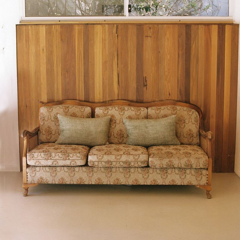 The cane lounge under the timber wall